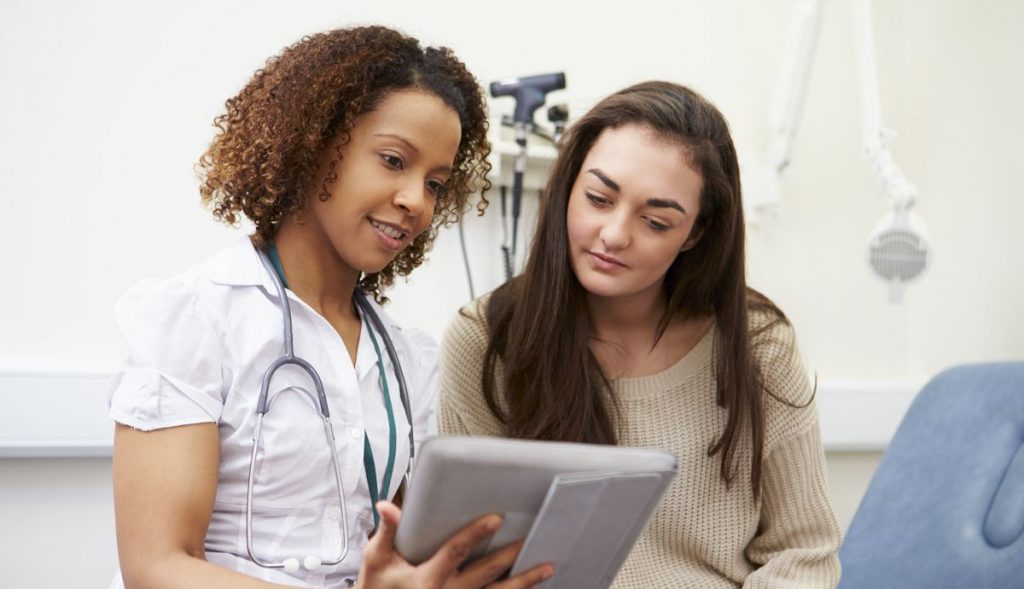 Healthcare provider helping a patient navigate patient assistance programs